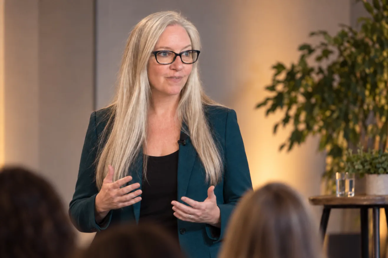 Deborah Parker speaking with an audience at a professional event